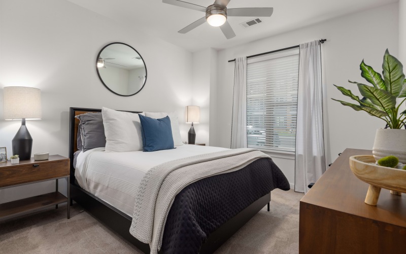 a bedroom with a bed and a plant
